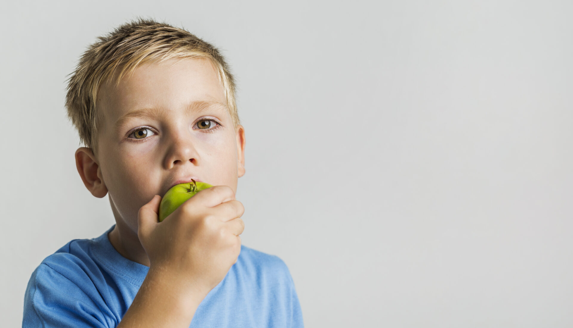 cute-kid-bitting-green-apple